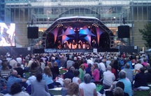 The orchestra and The Jiving Lindy Hoppers on stage at Canary Wharf.